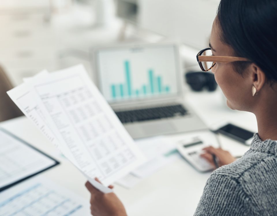 woman reading documents at desk