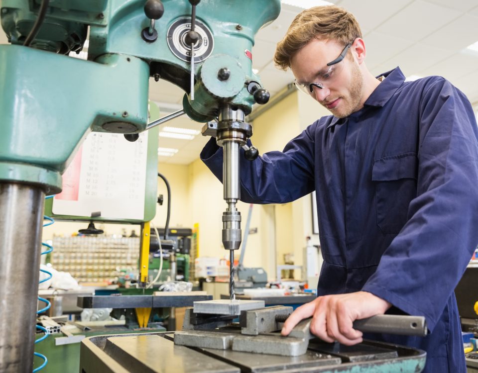 large drill being used by engineering student in manufacturing