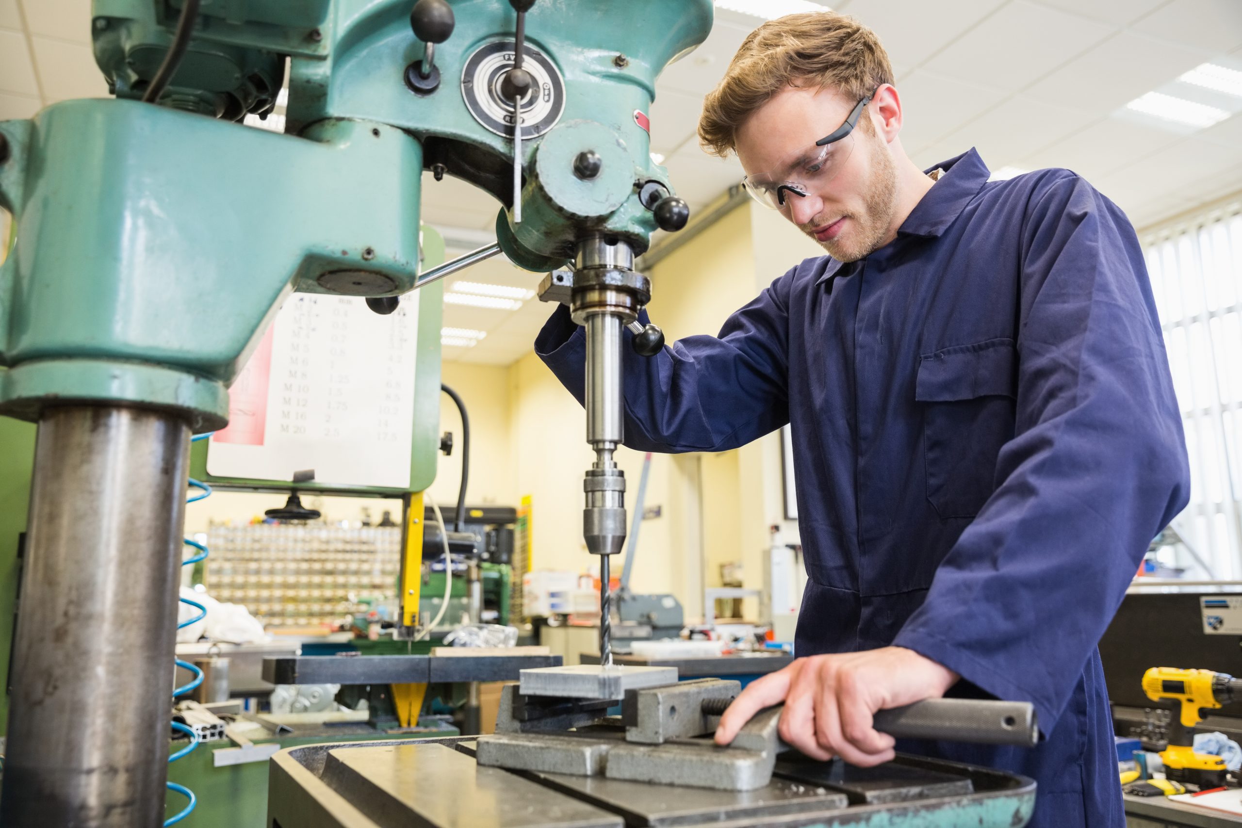 large drill being used by engineering student in manufacturing