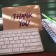 thank you card next to keyboard