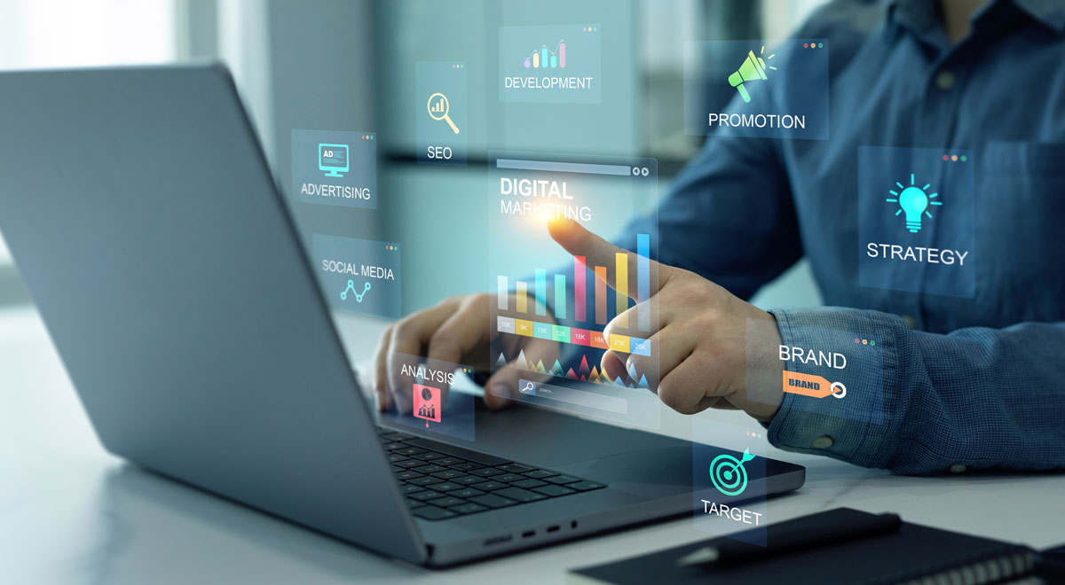 Marketing-Computer Man at laptop with marketing concepts shown